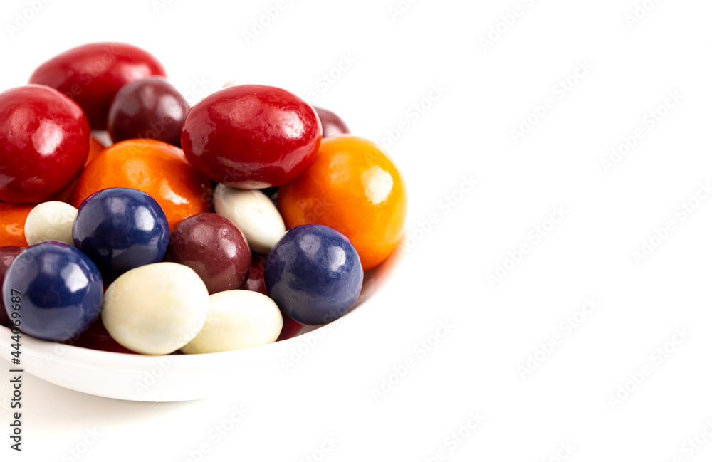 A Mix of Candy Coated Chocolate Covered Dried Fruit Isolated on a White Background A Mix of Candy Coated Chocolate Covered Dried Fruit Isolated on a White Background