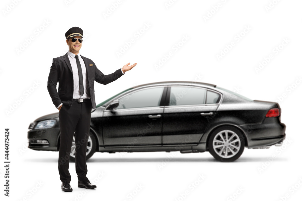 Full length portrait of a chauffeur showing a black car Full length portrait of a chauffeur showing a black car