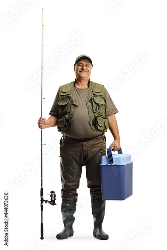 Full length portrait of a fisherman with a fishing rod and a portable fridge