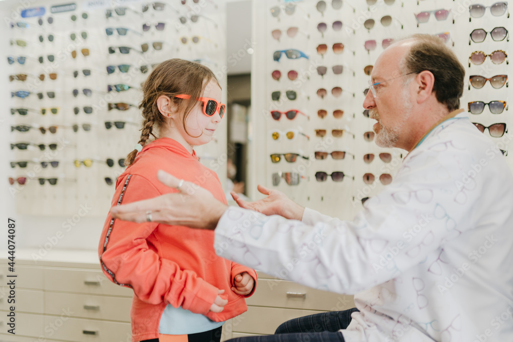Young girl trying out sunglasses