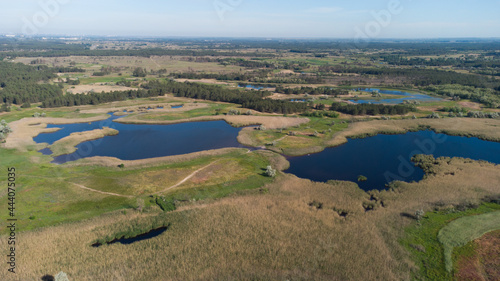 Top aerial view of lakes between green fields and forest. Ukraine © Yevheniia Kudrova