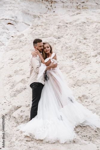 Beautiful wedding couple bride and groom at wedding day outdoors at ocean beach. Happy marriage couple o