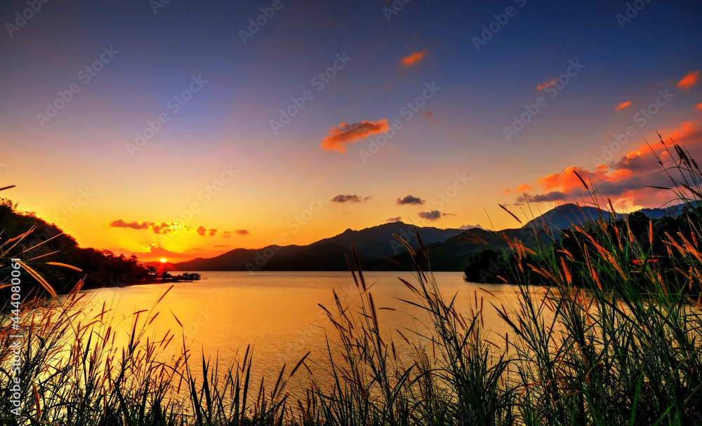silhouette, grass and evening light water dam 
