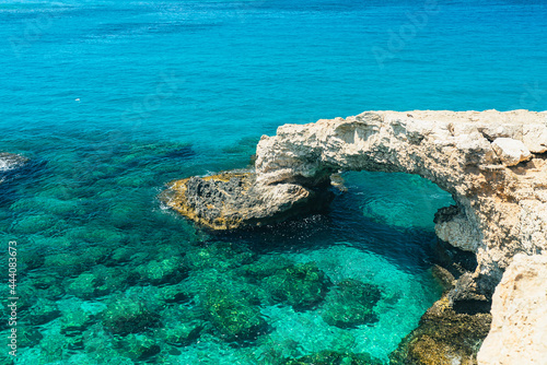Beautiful natural rock arch near of Ayia Napa on Cyprus island, Mediterranean Sea. Legendary bridge lovers. Amazing blue green sea and sunny day