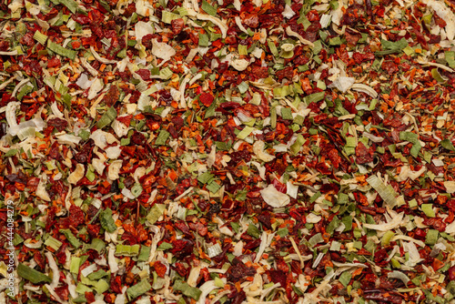 Seasoning for soup, dried vegetables slices background.