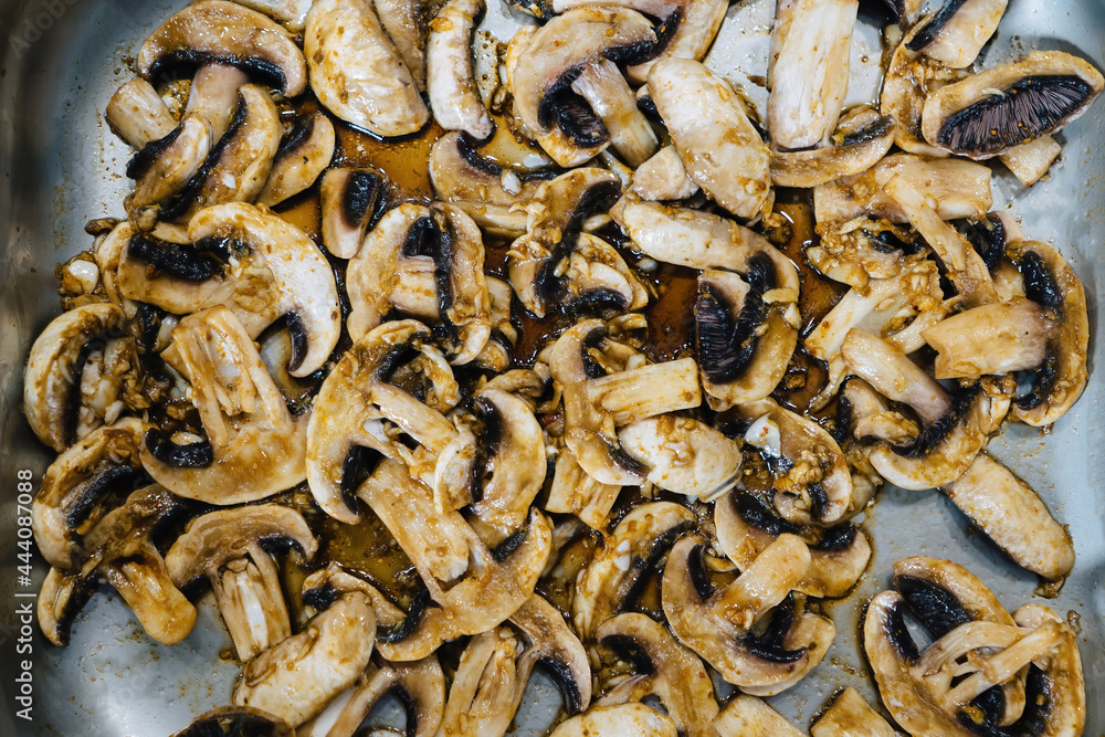 roasted mushrooms champignons on an iron baking sheet. Catering blanks.