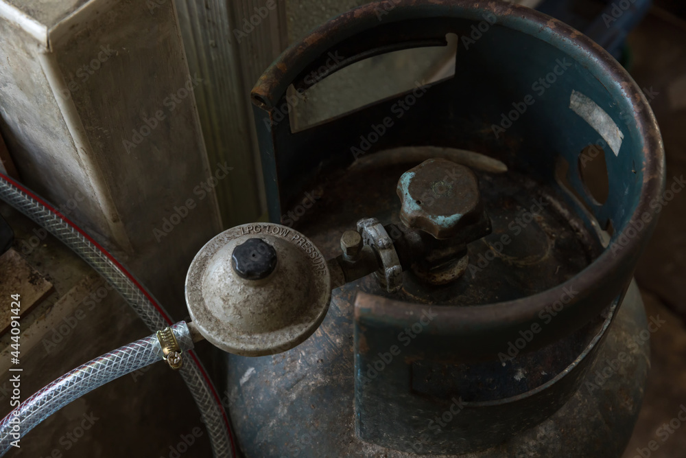 Rusty pressure regulator and operating valve of cooking gas tanks. LPG . Hose connect to the cylinder red gas supply. Rusty pressure regulator and operating valve of cooking gas tanks. LPG . Hose connect to the cylinder red gas supply.