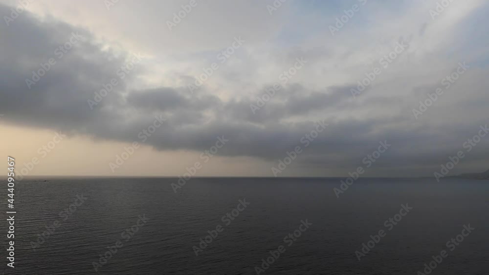 Timelapse of dark clouds moving over the sea at dusk Timelapse of dark clouds moving over the sea at dusk