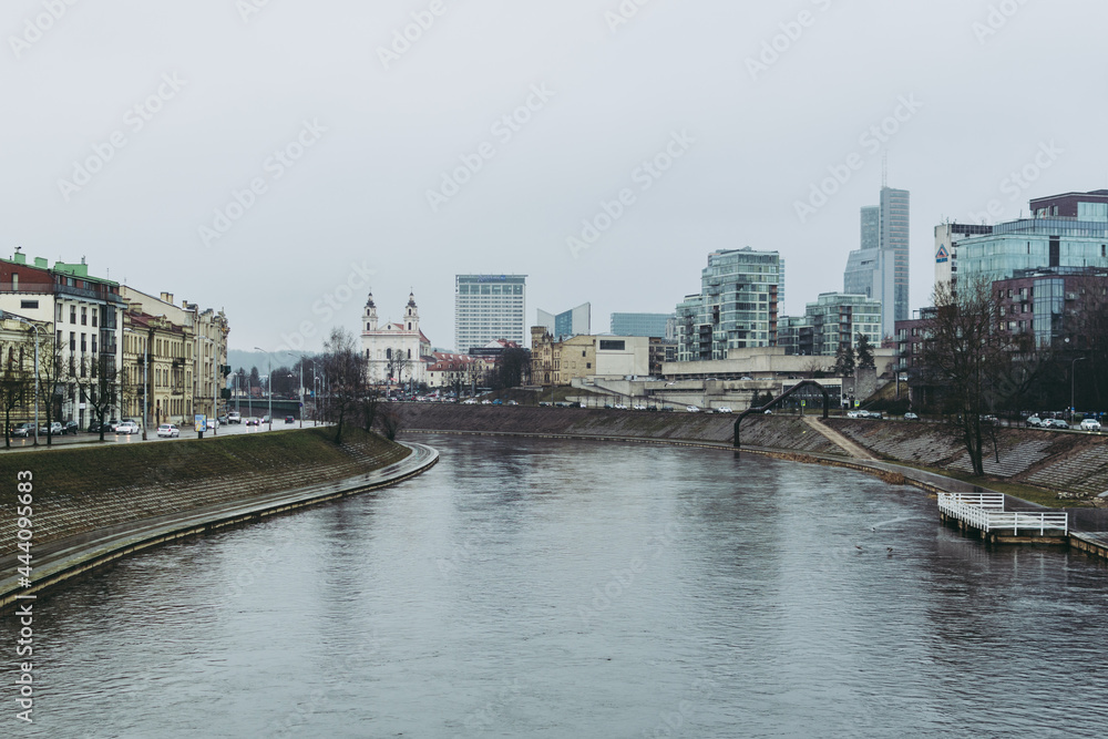 Vilnius cityscape with Vilnia river and skyscrapers on the background