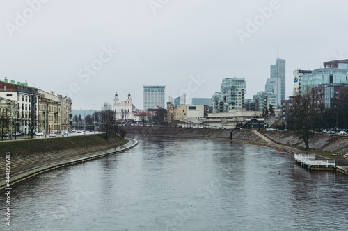 Vilnius cityscape with Vilnia river and skyscrapers on the background © Yurii Zymovin