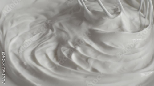 Yogurt is whipped with a mixer close up