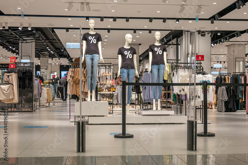 Wallpaper Mural Seasonal sale. Mannequins wearing black t-shirts with percent sign standing inside clothing store during shopping sale period Torontodigital.ca