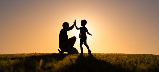 Father giving son high five. Parent child relationship concept 
