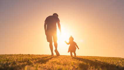 Father holding his little girls hand showing support. Parent child relationships concept.  