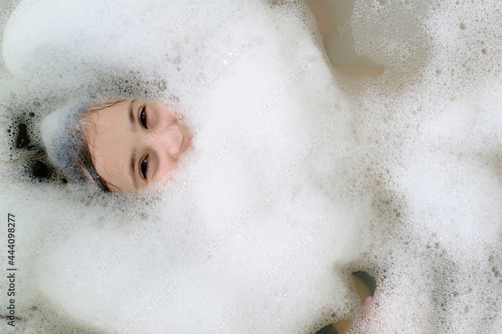 Girl's Face Peeking out from Bubbles in the Bath Tub Girl's Face Peeking out from Bubbles in the Bath Tub