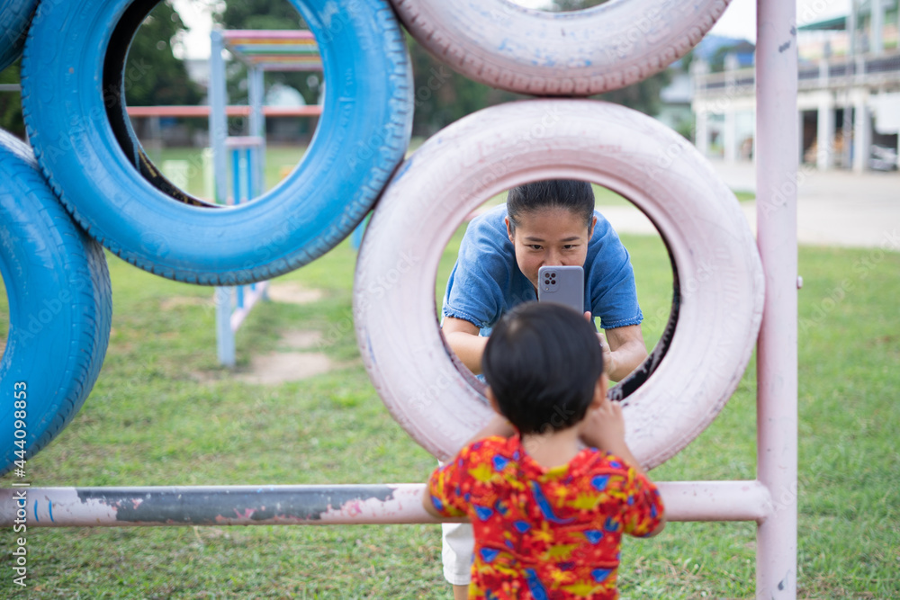 Asian boy playing in outdoor playground Asian boy playing in outdoor playground