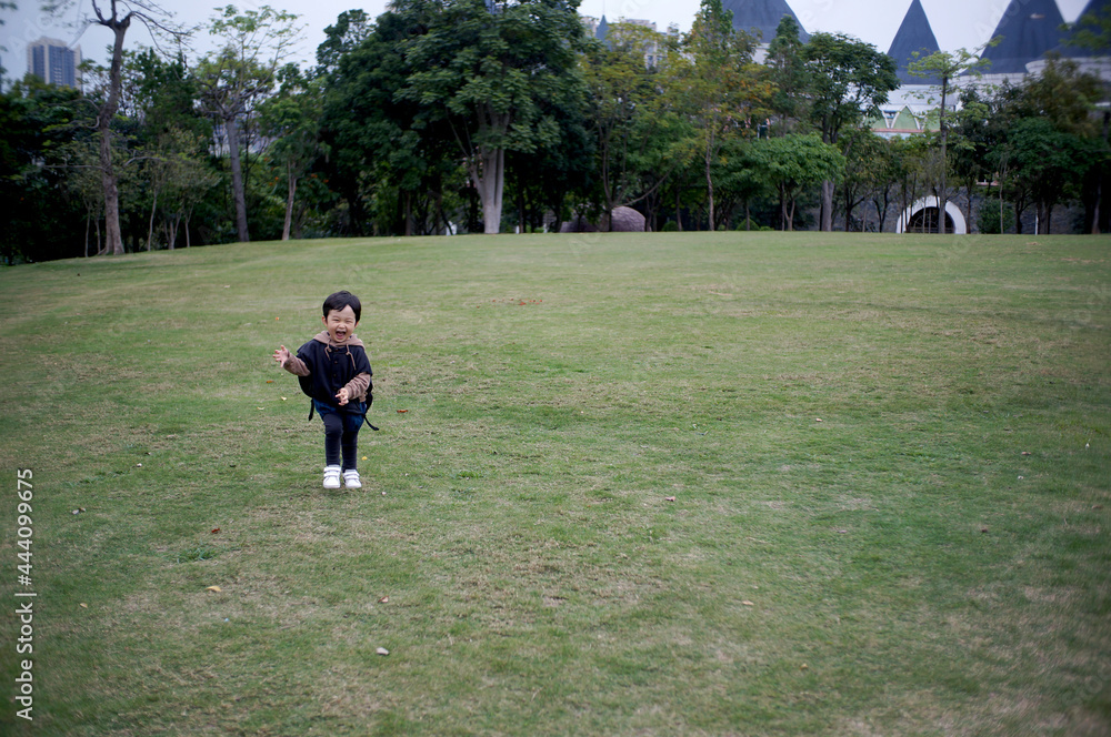 Cute Asian Chinese little boy playing outdoors Cute Asian Chinese little boy playing outdoors