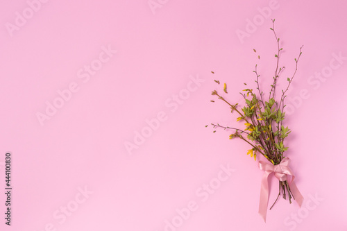 Spring bouquet from twigs with first leaves and flowers. Copy space.