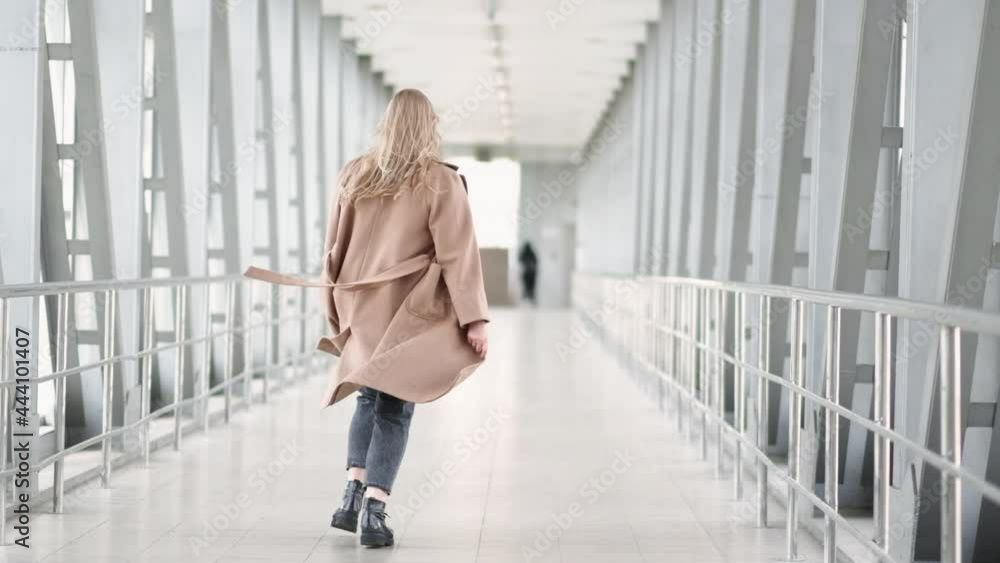 Plus size fashion. Body positive. Casual look. Self-acceptance success. Confident carefree overweight obese chubby model woman running away turning around on light bridge. Plus size fashion. Body positive. Casual look. Self-acceptance success. Confident carefree overweight obese chubby model woman running away turning around on light bridge.