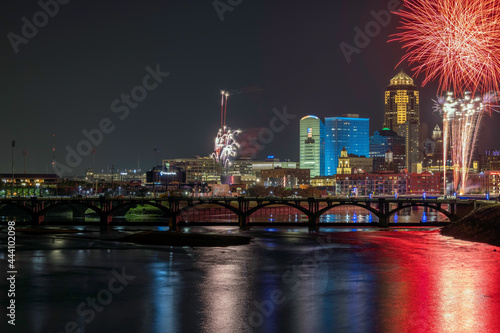 Fireworks over the Des Moines skyline with reflections in the Des Moines River during Fourth of July celebration