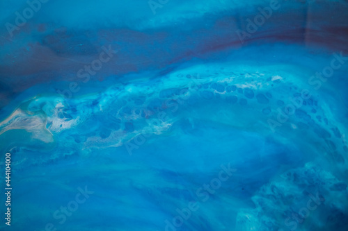Part of original resin art epoxy resin painting. High quality details. Marble texture. Fluid art for modern banners, ethereal graphic design. Abstract ethereal bronze, blue and white swirl.