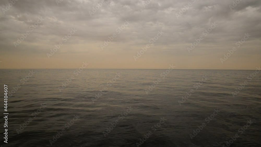 the movement of waves in sea water at sunset with clouds extending to the horizon the movement of waves in sea water at sunset with clouds extending to the horizon