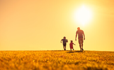 parent father and children playing at sunset