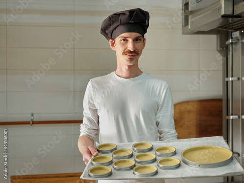 Portrait of a baker with baking pies photo