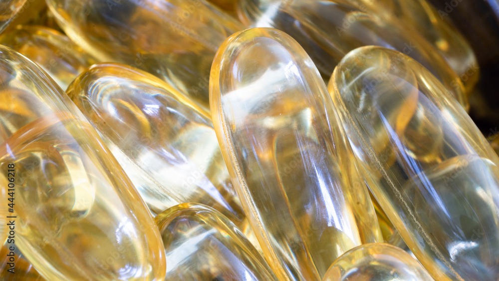 Astonishing closeup of Omega 3 capsules (pills), stacked together in a pile. Medical journals and life sciences concept. Astonishing closeup of Omega 3 capsules (pills), stacked together in a pile. Medical journals and life sciences concept.