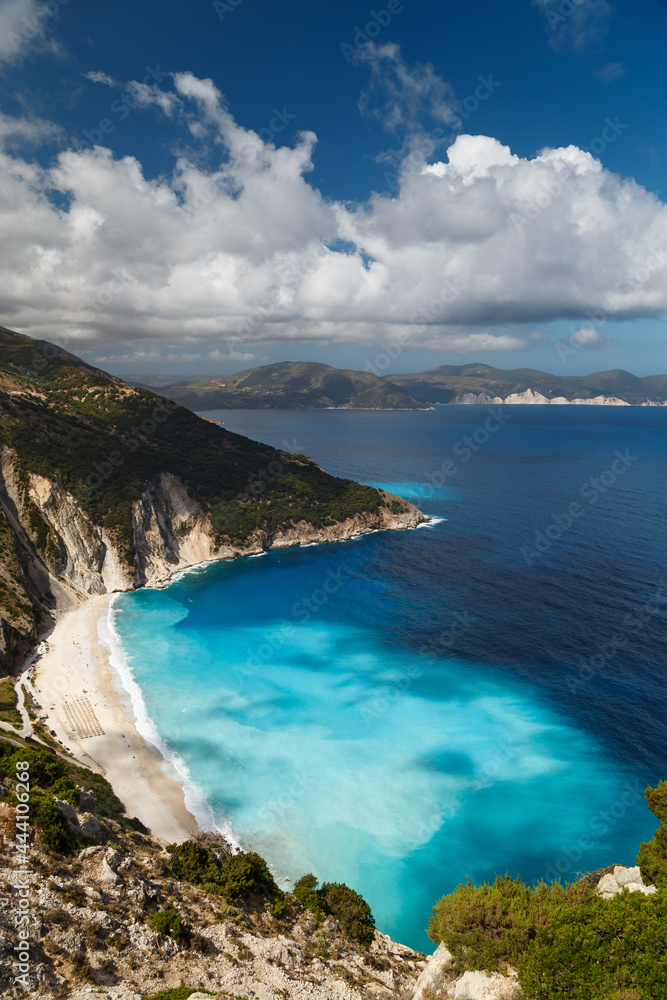 A top view at Myrtos Beach and fantastic turquoise and blue Ionian Sea water. Aerial view, summer scenery of famous and extremely popular travel destination in Cephalonia, Greece, Europe.