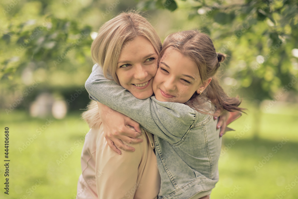 happy mother with her daughter hugging a teenager in the summer. Caring happy mother enjoy day with teenage girl child, laugh have fun. Mother giving her daughter advice. happy mother with her daughter hugging a teenager in the summer. Caring happy mother enjoy day with teenage girl child, laugh have fun. Mother giving her daughter advice.