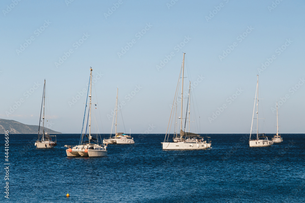 White yachts anchored in a blue bay of Agia Efimia port, Cephalonia island, Greece