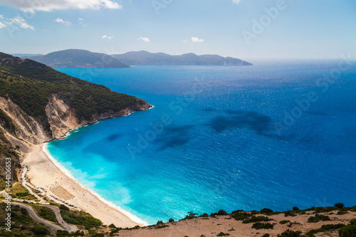 A top view at Myrtos Beach and fantastic azure Ionian Sea water. Aerial view, summer scenery of famous and extremely popular travel destination in Cephalonia, Greece, Europe.