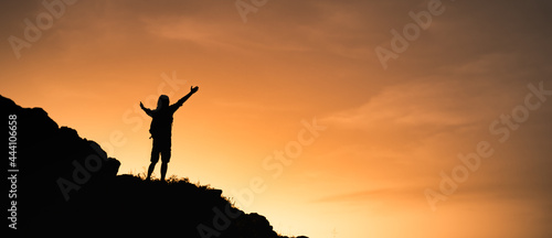 Young man feeling free on a mountain top. 