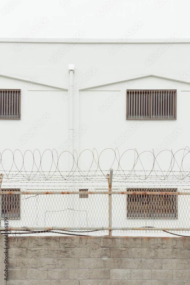 Close-up of a building wall surrounded by barbed wire Close-up of a building wall surrounded by barbed wire