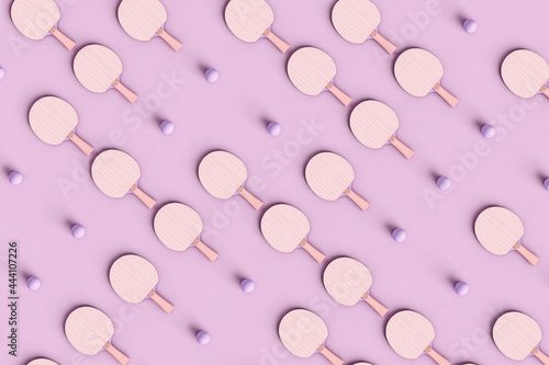 pattern of Ping pong rackets on violet background photo