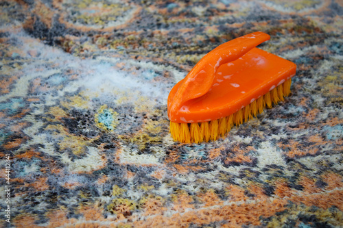 Hand wash carpet with a brush. Washing. Close-up. Background. Texture.