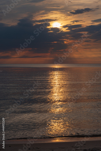 sunset in the sea with clouds and calm water