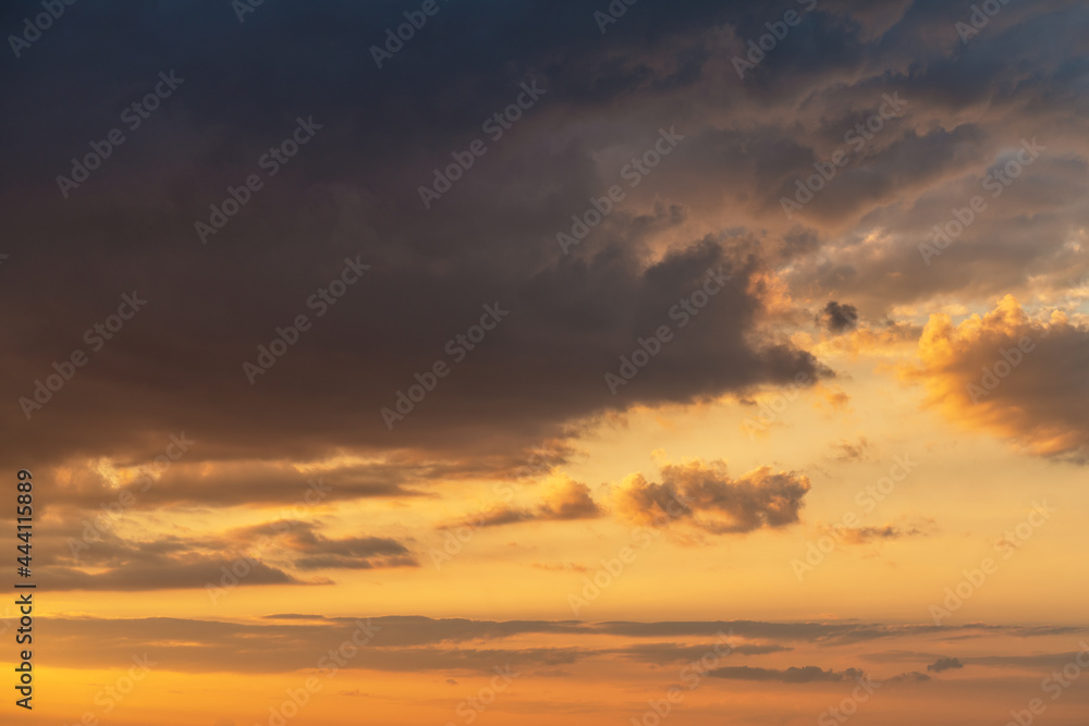 orange sunset sky with lighted clouds