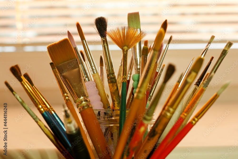 Fototapeta premium Many different art paint brushes in a container