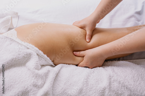 Anti-cellulite massage in the spa salon. The masseur massages the buttocks, thigh and legs. Relaxing treatment. Slimming and body shaping. Healthy body and skin. Self love care