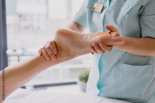 Foot massage close-up. Spa salon self-care relax. Kneading the feet. Pleasant pleasures. The masseur is working. Treating fatigue and leg pain. Health care acupuncture. massaging Heel fingers foot