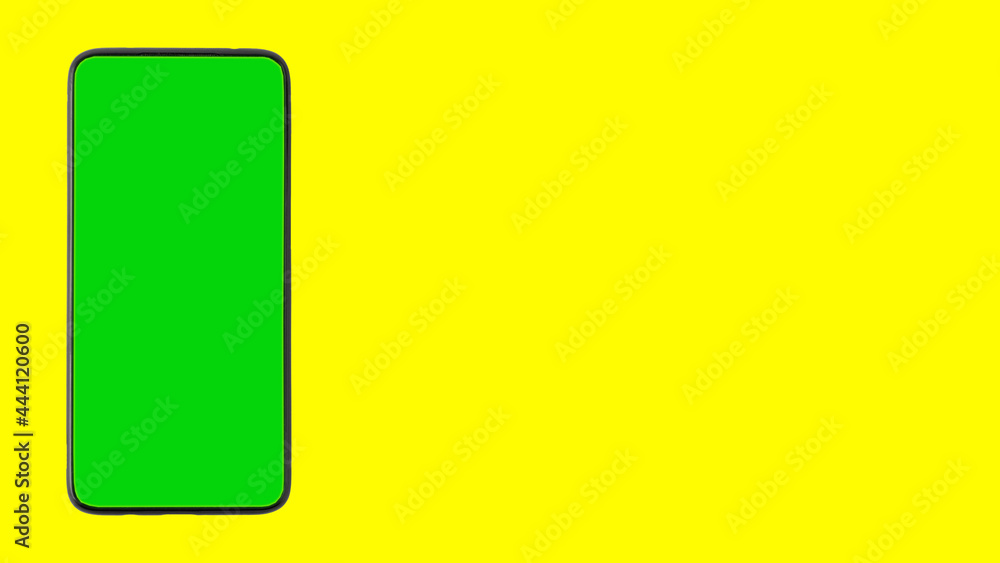 A smartphone with a chroma key instead of a screen on a yellow background. Isolate. Copy space A smartphone with a chroma key instead of a screen on a yellow background. Isolate. Copy space
