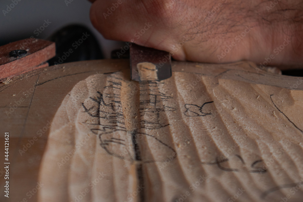 Luthier's hands using gouge to work the wood and make a violin Stock ...