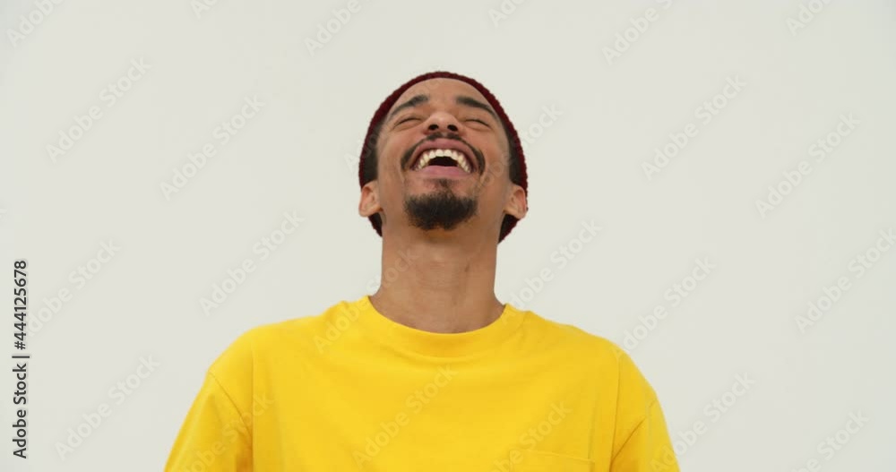 Handsome black bearded man laughing and looking camera isolated over white Handsome black bearded man laughing and looking camera isolated over white