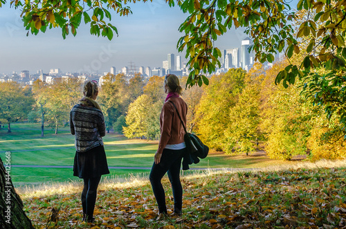 Two women friends at Greenwich Park in autumn, London