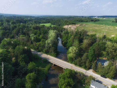 Aerial view looking north over the Creditview Road bridge over the Credit River in the Cheltenham area, a community within the town of Caledon, Ontario, Canada. Shot by a drone on a hazy summer aftern photo