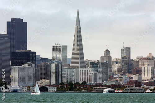 view of the transamerica pyramid, the financial district, and the san francisco, california,  skyline, from the alcatraz ferry in san francisco bay