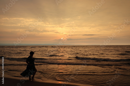 person on the beach at sunset
