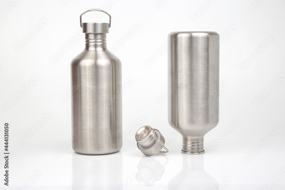 Steel flasks for water and drinks on a white background. Survival hiking gear Steel flasks for water and drinks on a white background. Survival hiking gear
